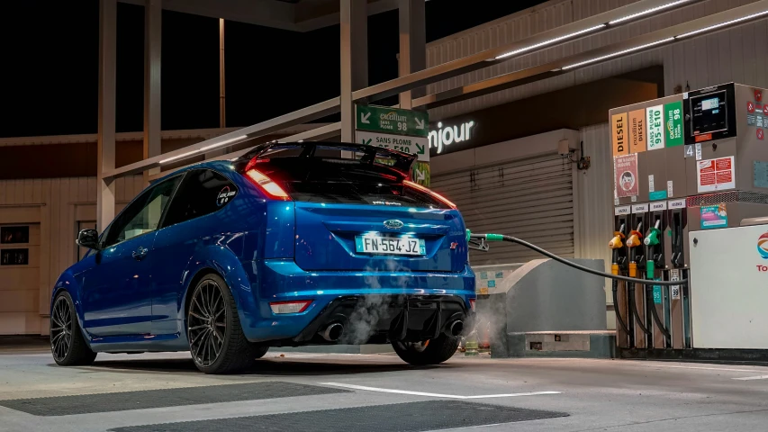 a blue car hooked to an electric power station