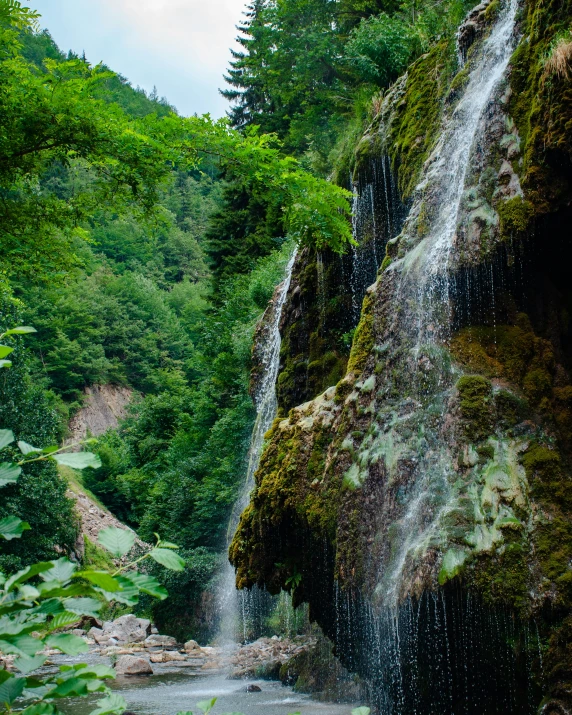 waterfall near stream in rocky area with lots of water