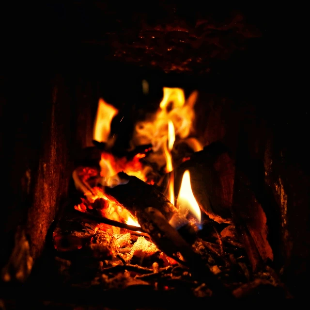 an open fire is lit in the dark