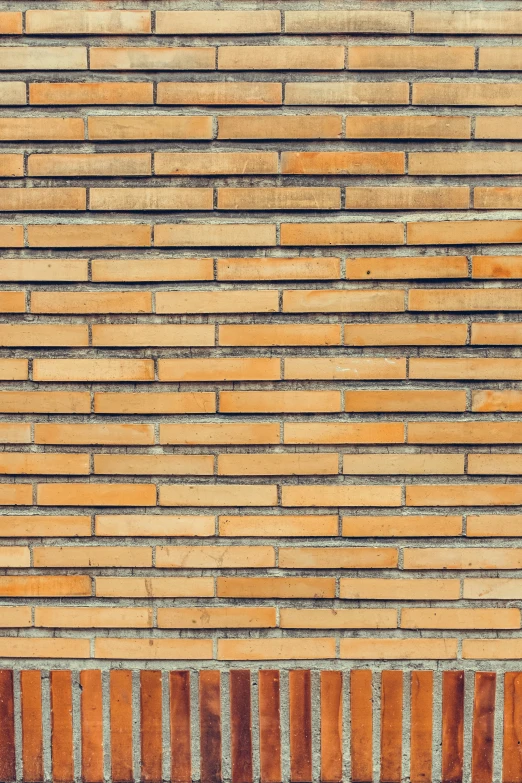 a brick wall has orange and white stripes on it