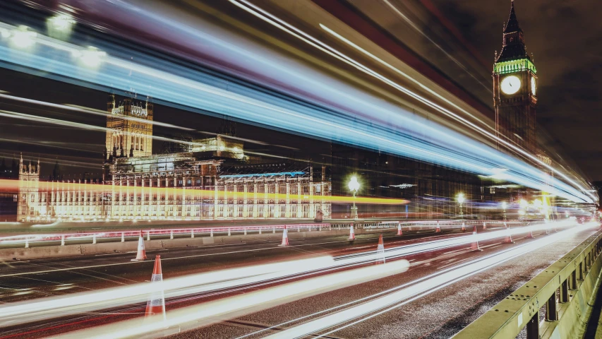 a city with many buses moving around and lights streaking down