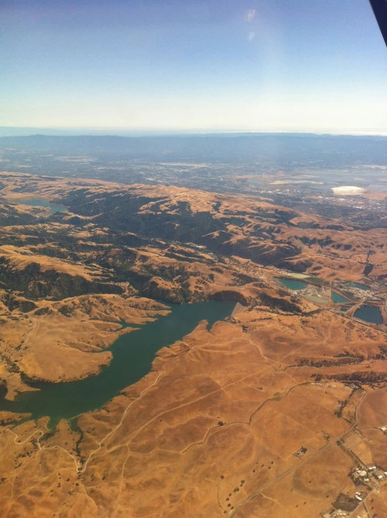 an aerial view of some green water in a dry area