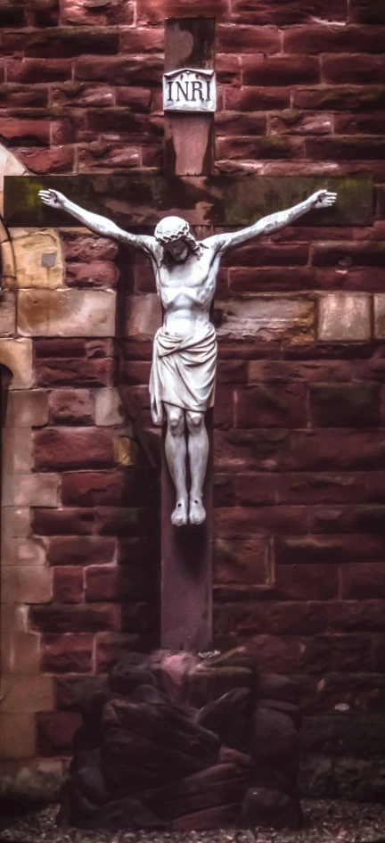 a picture of a statue of jesus on a wall