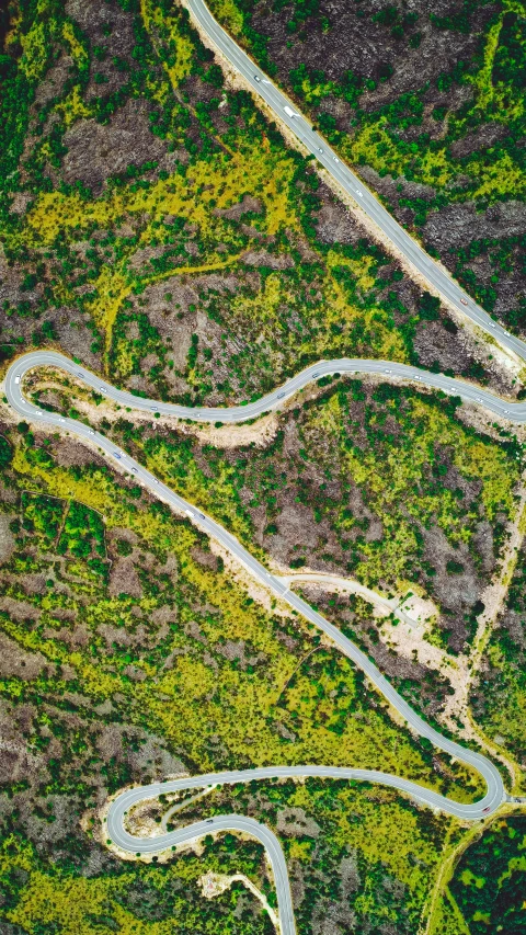 an aerial view of winding roads in the mountains