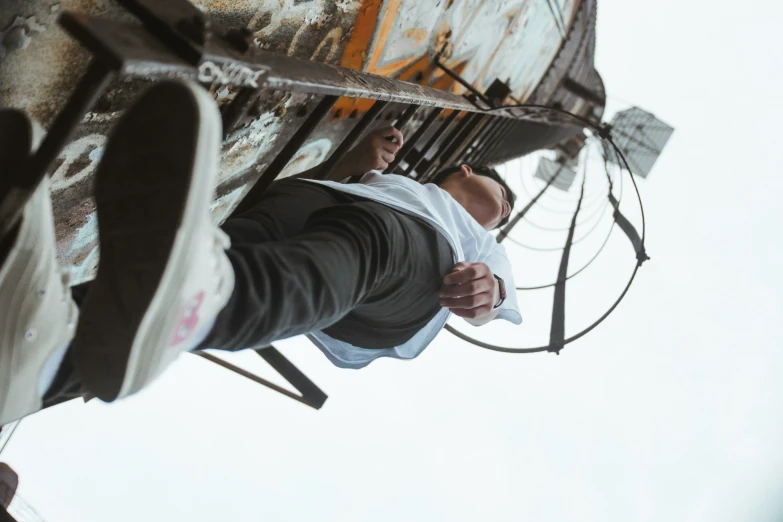 a young man is hanging upside down while standing on a basketball court