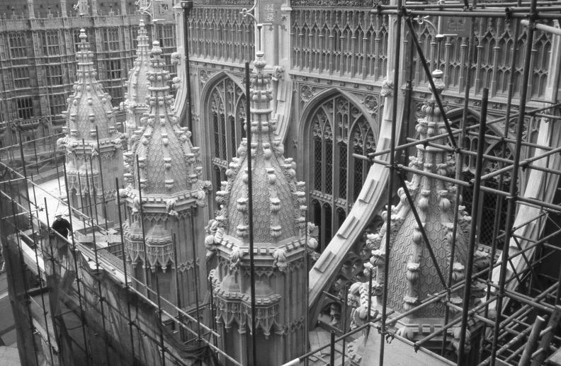 workers and scaffolding are on the side of a large building