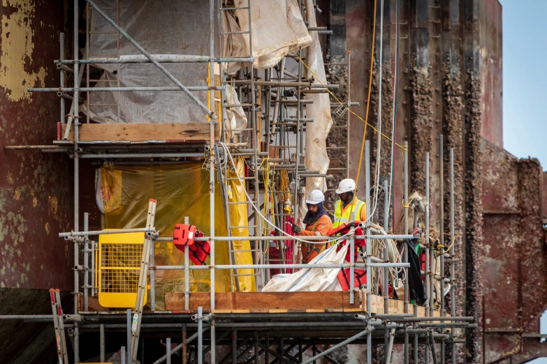 there are people that are on a building under construction