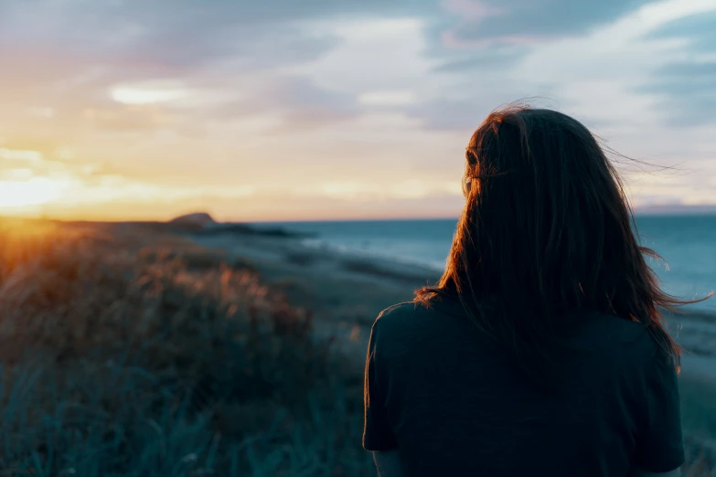 woman with her head back facing the sun