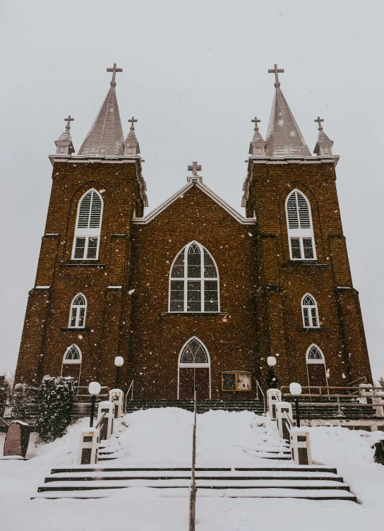 the church is surrounded by snow with tall towers