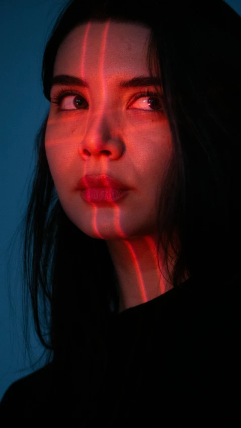 a woman making an evil face with light on her face