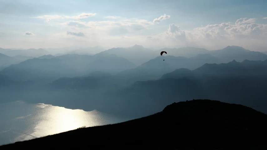 the silhouette of mountains and a body of water