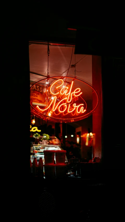 a dark po of a neon sign that says cafe nikola