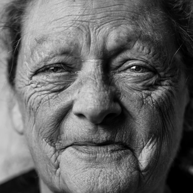 an elderly woman is smiling for a po