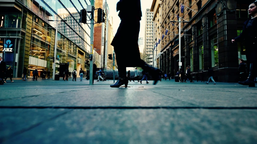 a person standing on the side of a street holding an umbrella