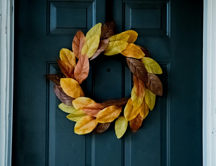 a wreath is on the front door of a house