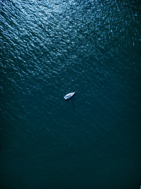 an aerial view shows a paddle boat in the ocean