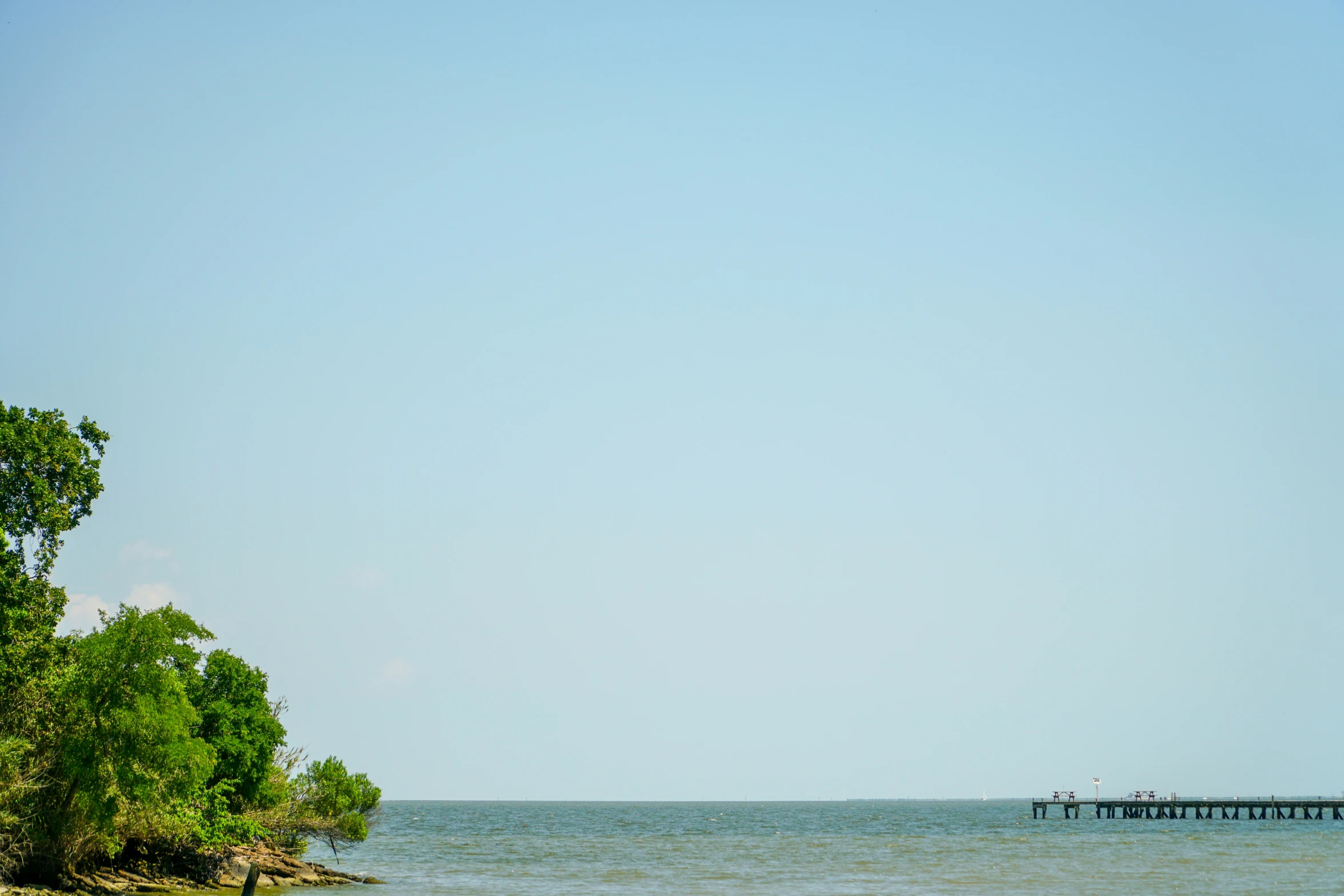 two people are sailing on the blue waters of the ocean