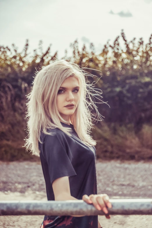 a blonde woman with long hair and black shirt