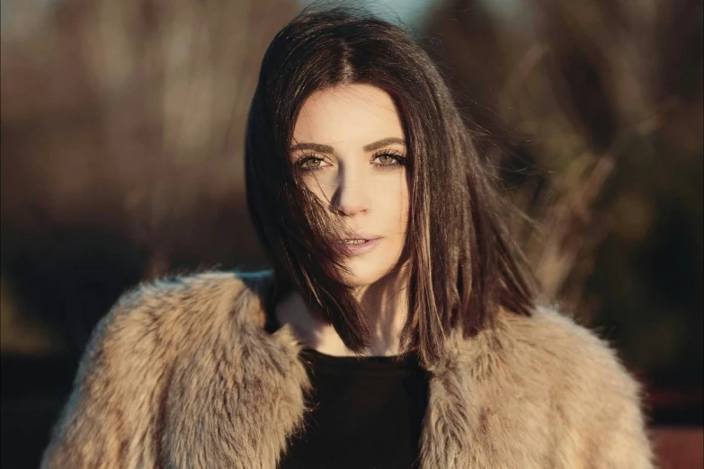 a woman in a fur coat posing for the camera