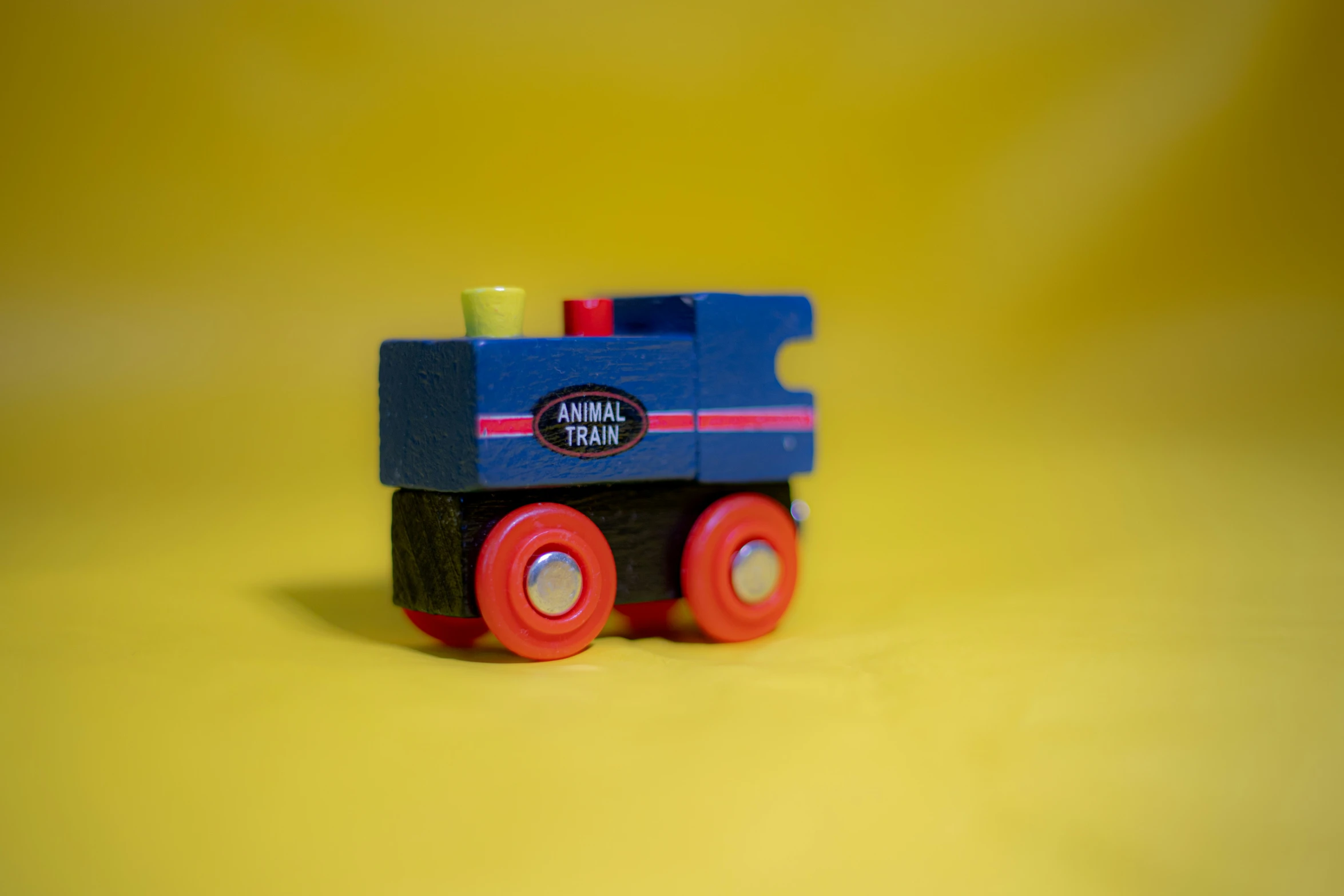 a toy train sitting on top of a yellow table