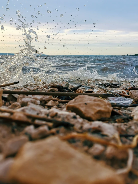 a group of rocks and water splashing over them