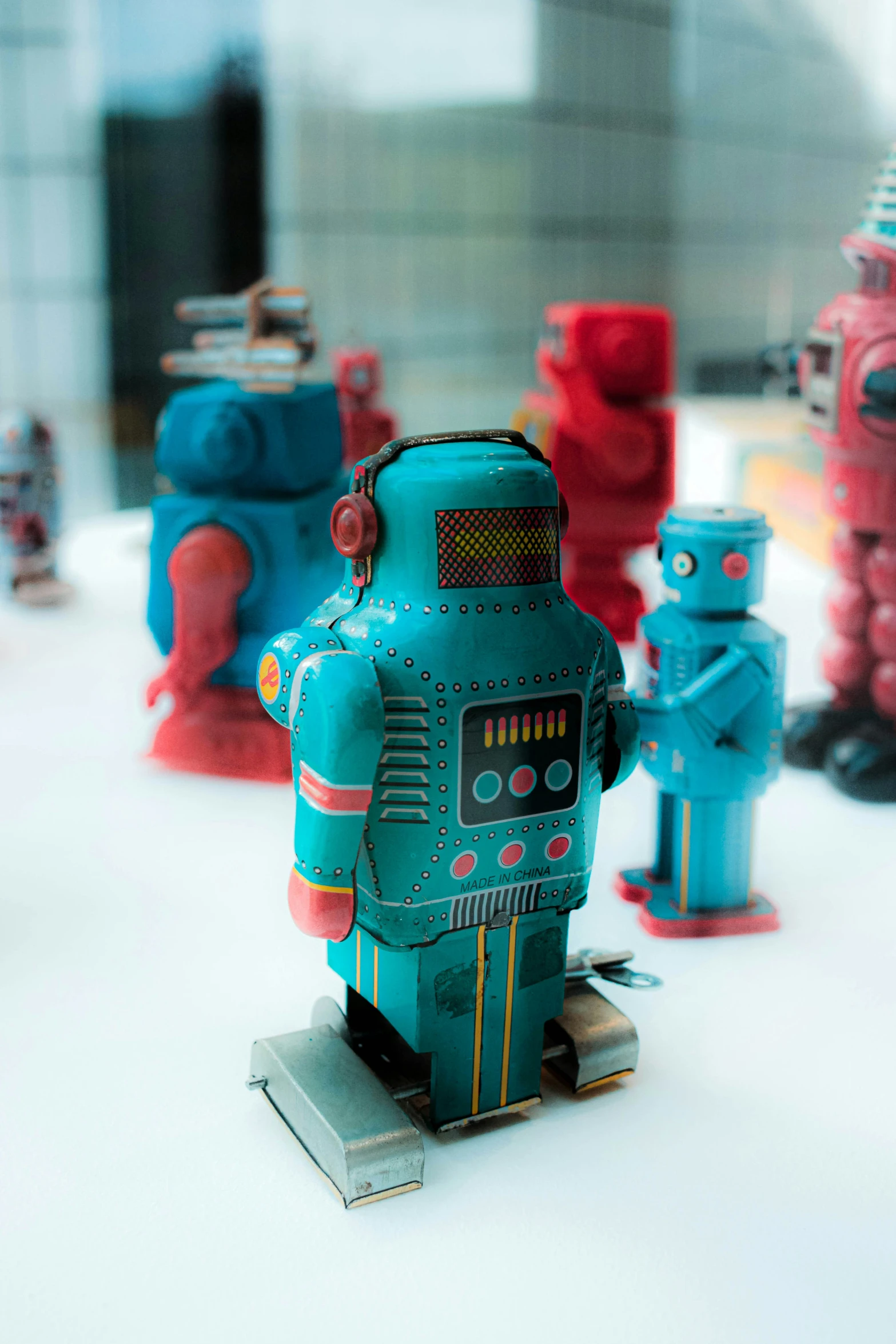 several toy robot figurines on display in a building