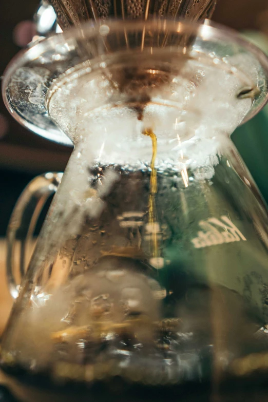 a glass carafe filled with ice sitting on top of a counter