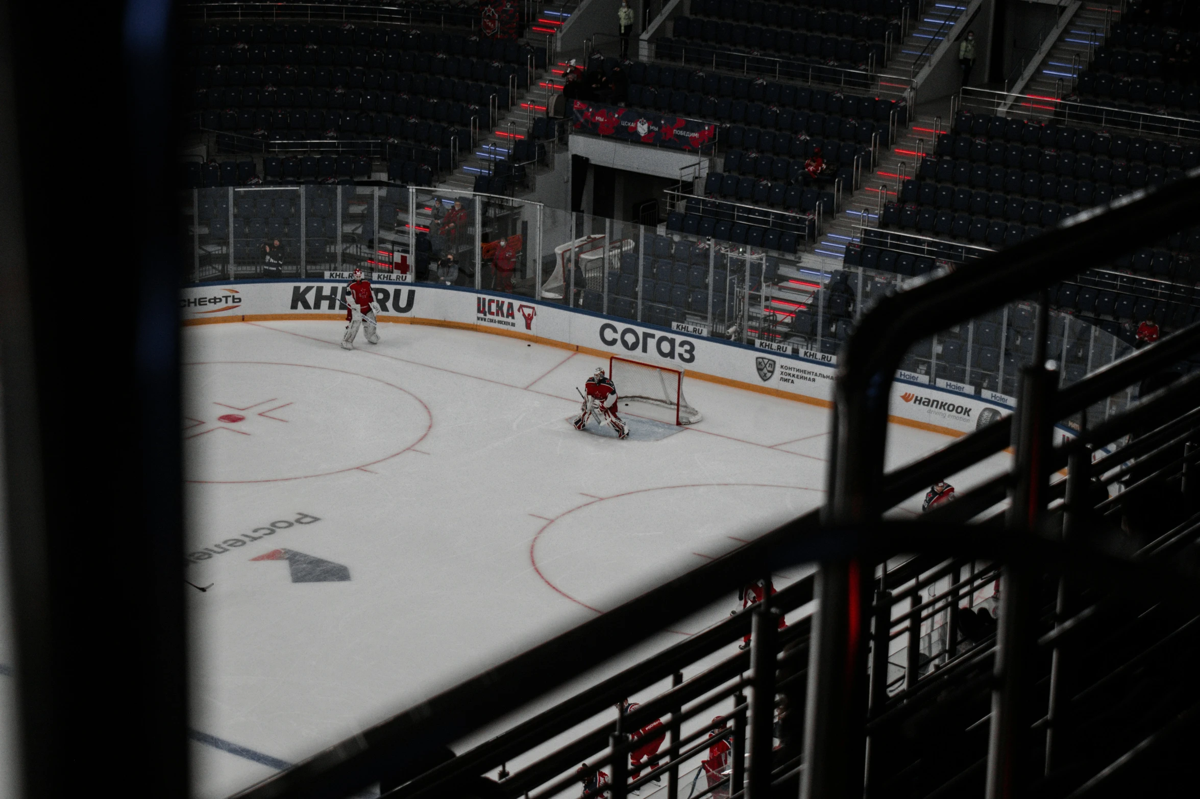 hockey players playing on the ice at night