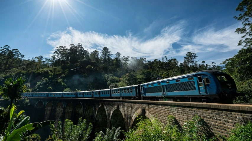 a train travels along the tracks near a bridge