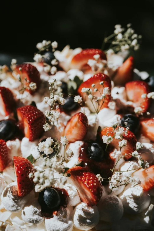 a dish of fruit and whipped cream