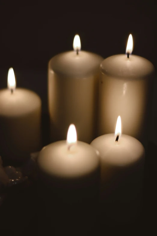 closeup of lit candles on a black background