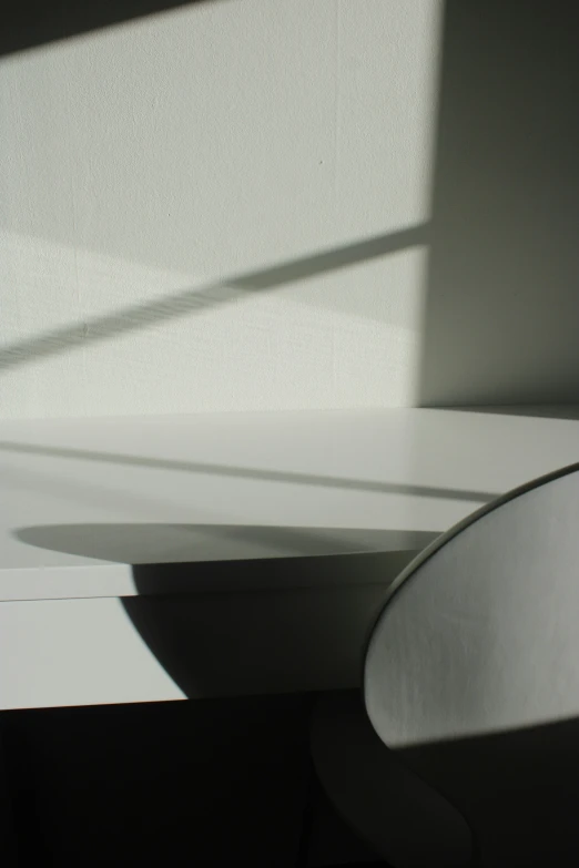 an angled view of a vase sitting on top of a desk