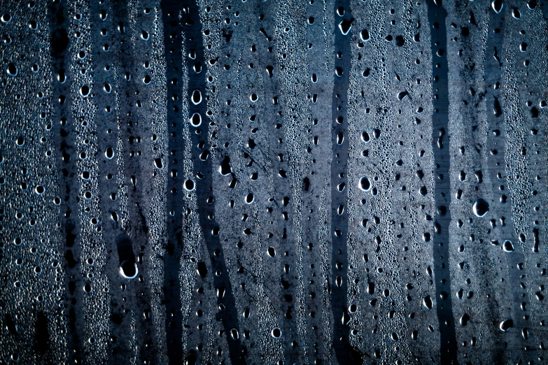 rain drops on the window glass with a black background