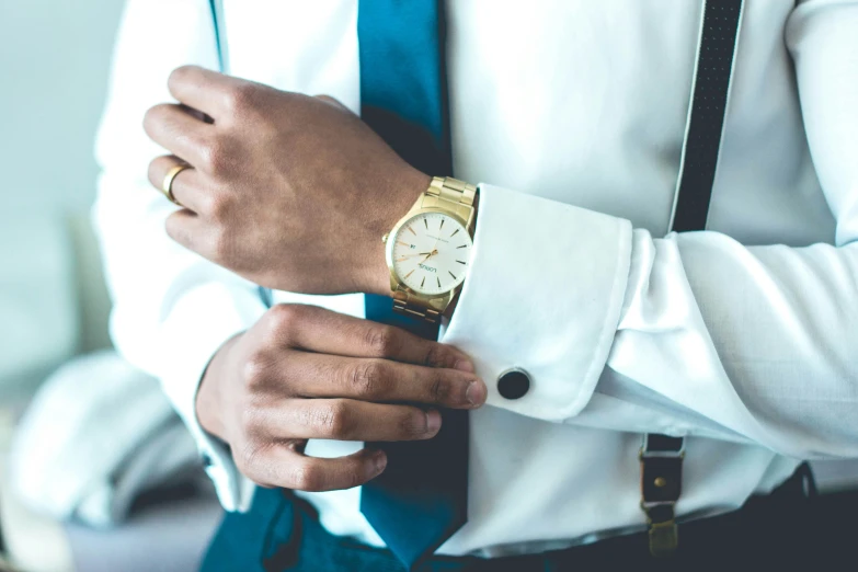 man in suit and tie wearing a yellow watch