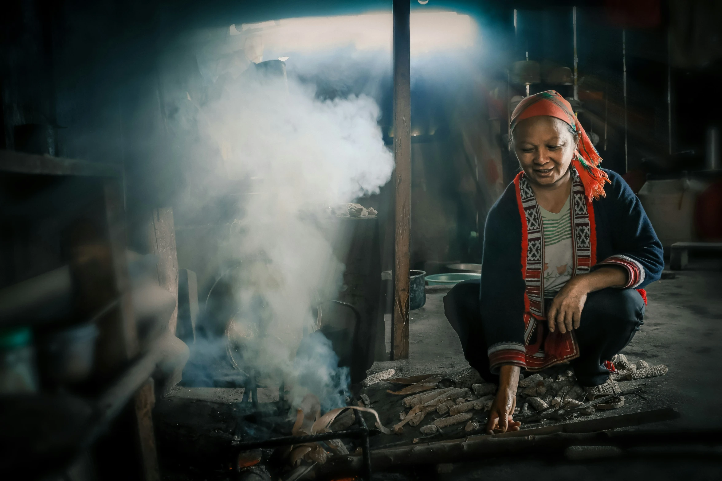 a woman preparing food in an outdoor cooking area