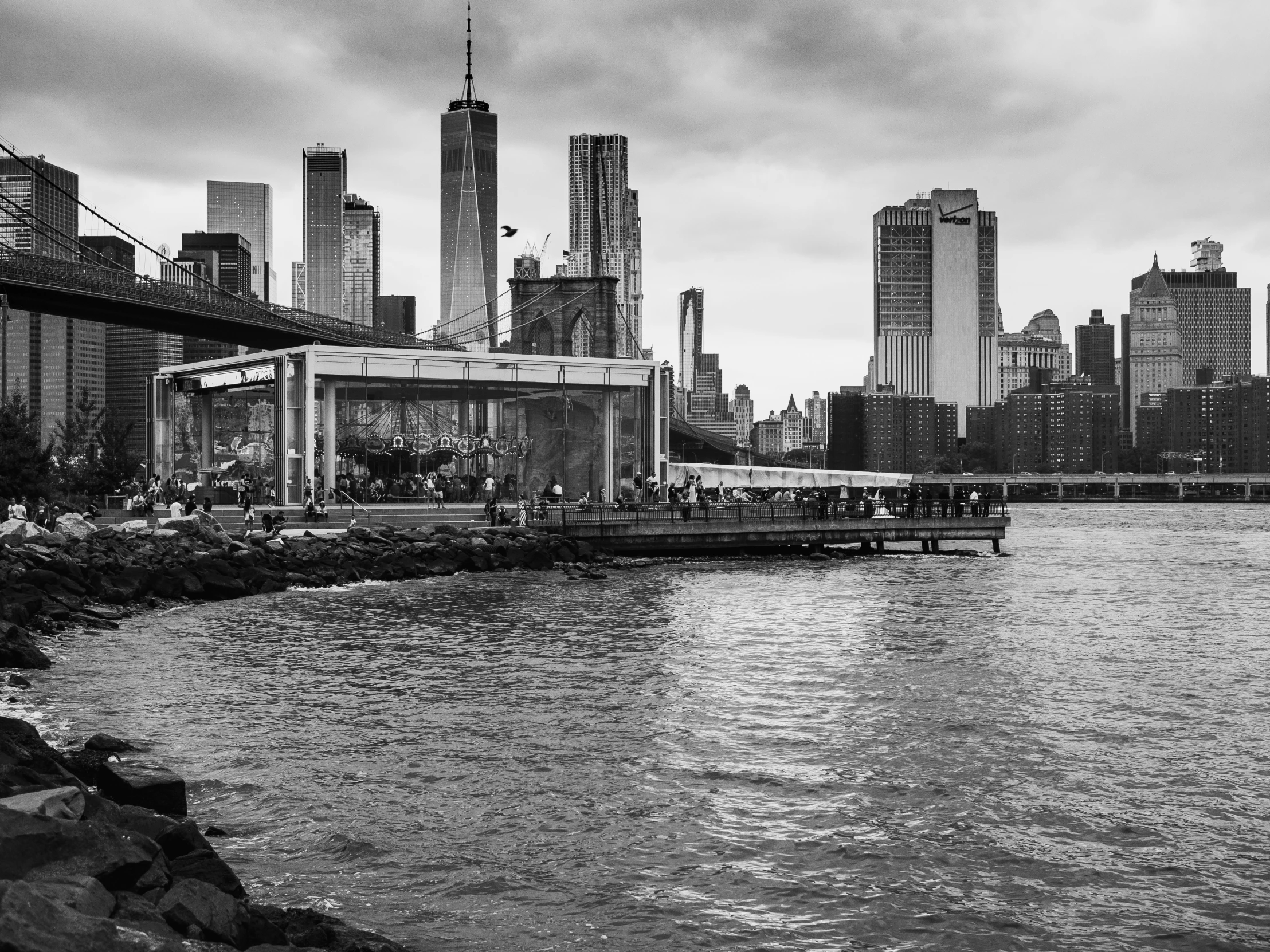 a boat with people near the shore by a city skyline