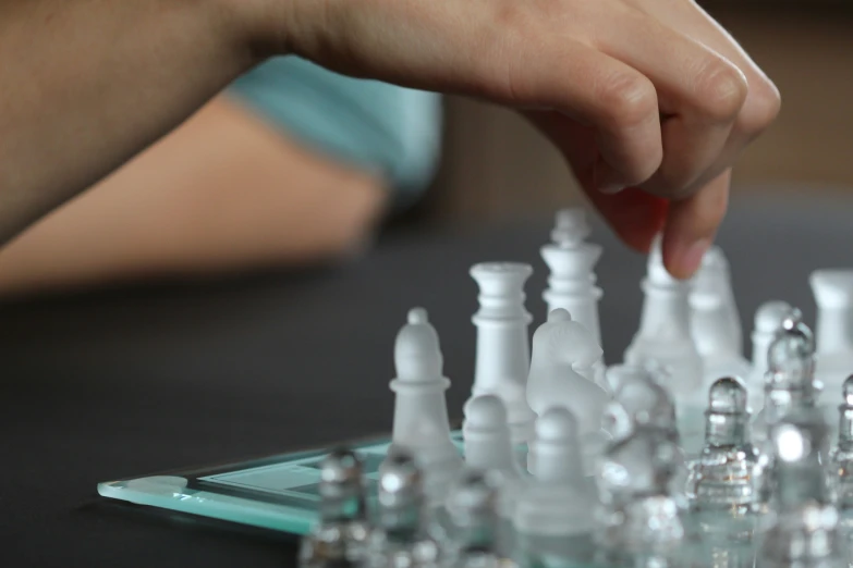 a child plays with plastic chess pieces