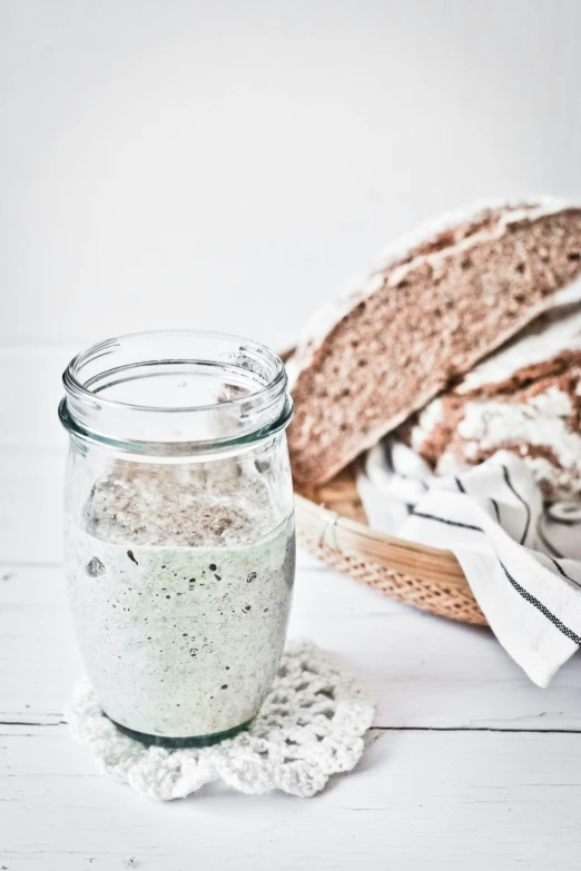 an open jar and some bread sitting on a table