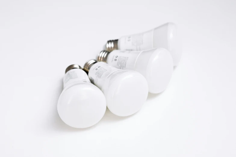 several bulbs on a white surface that are not properly lit