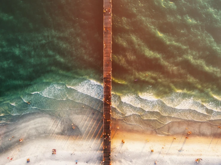 the beach is surrounded by large waves in the ocean