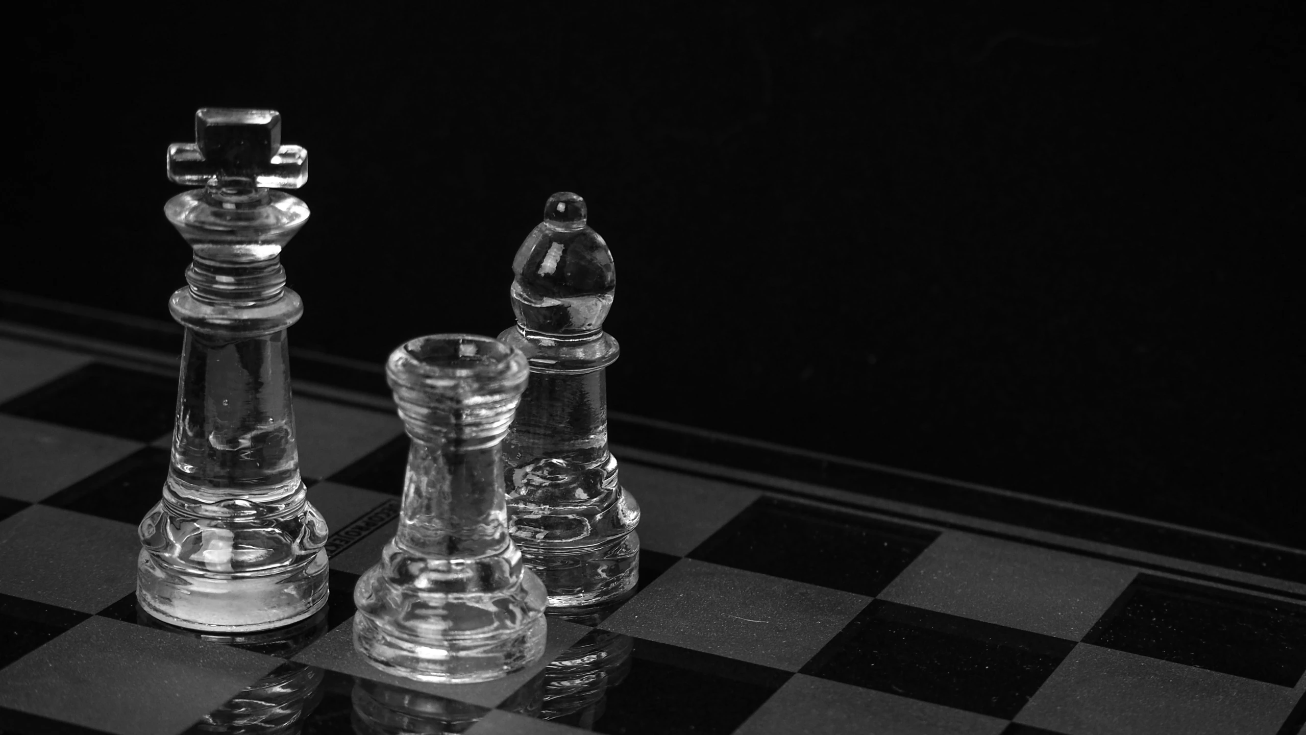 a glass chess board with a set on it