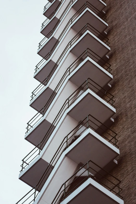 the building is brown and white with balconies