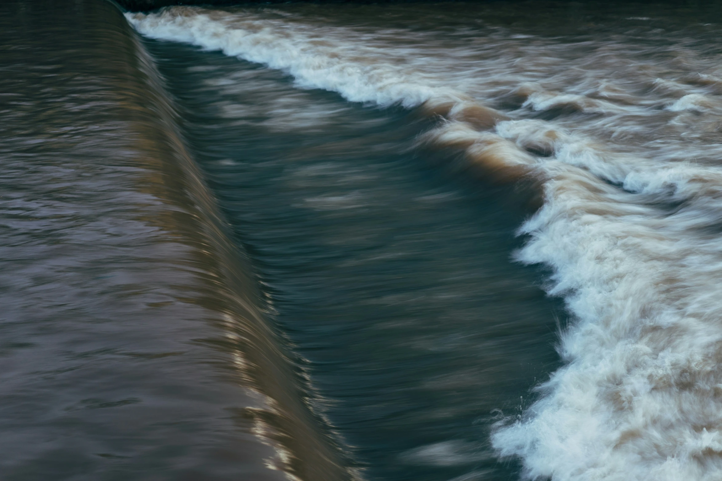 a wave breaking on the beach shore