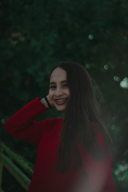 a girl posing for the camera with her hair blowing back