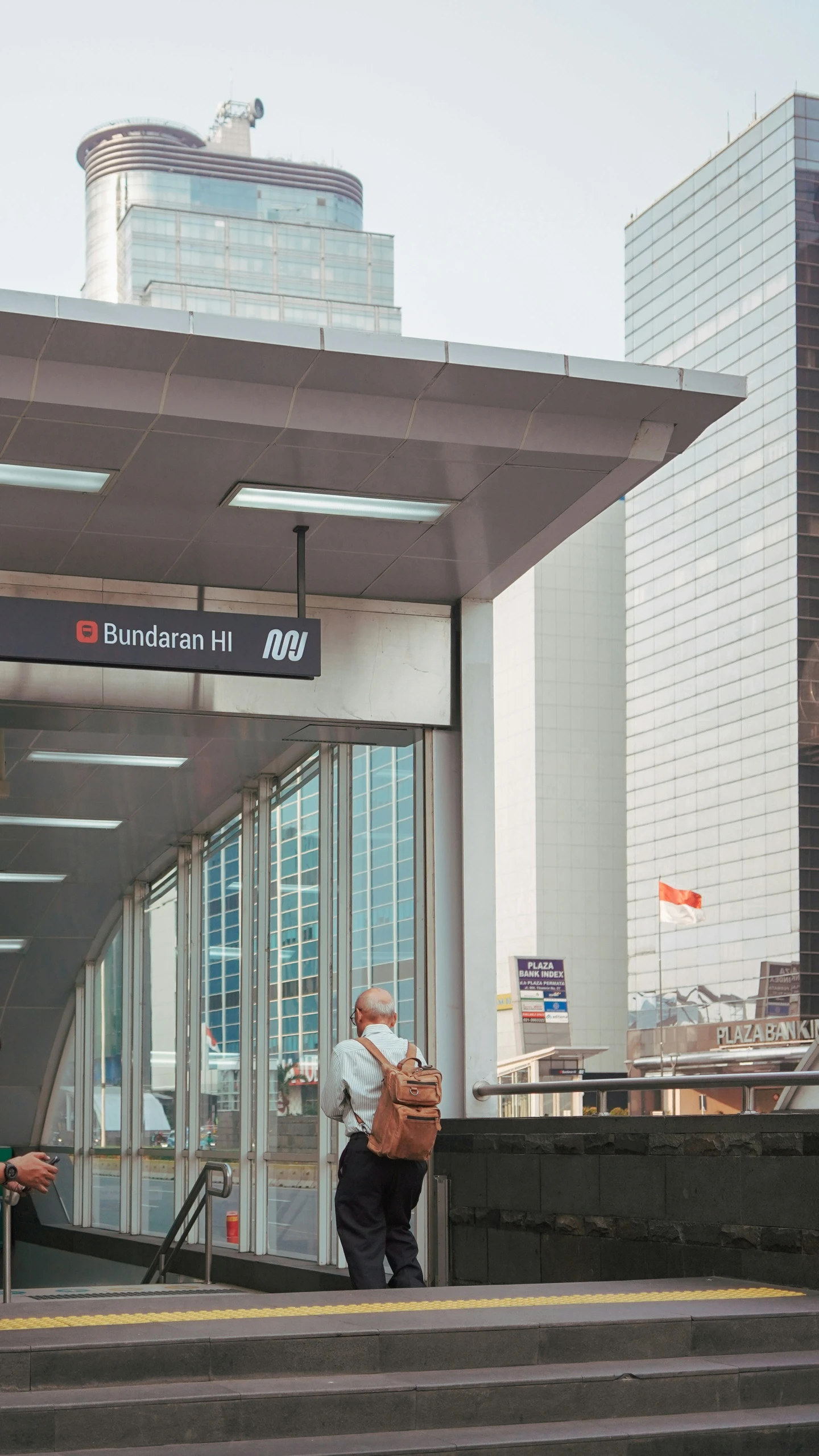 a man wearing a mask and carrying a backpack walking down a stair