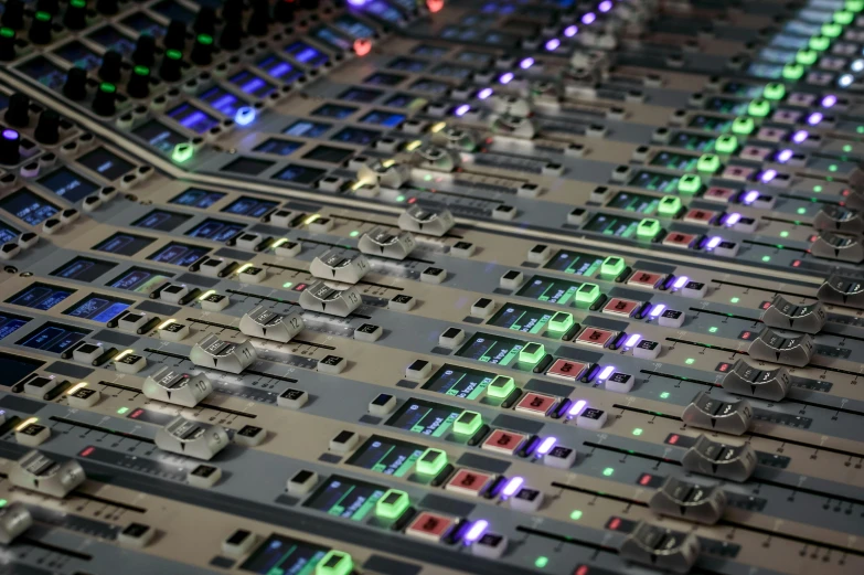 a sound board that looks like the soundboard has green and blue lights