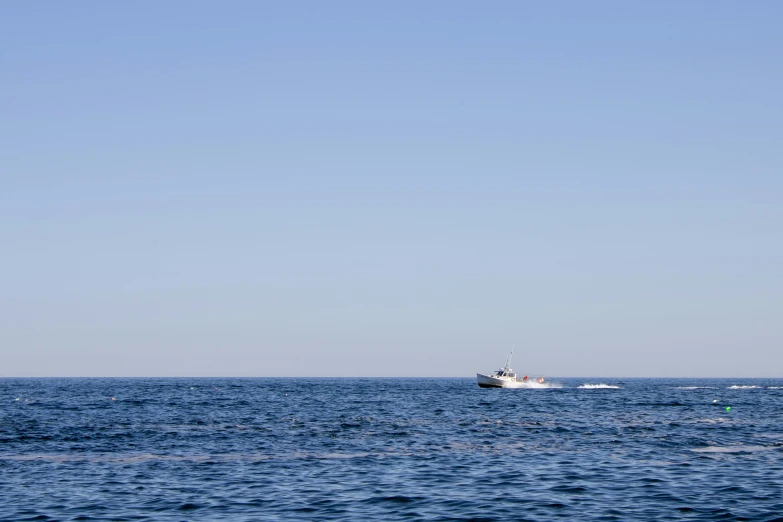 a boat in the water with two small boats in the background