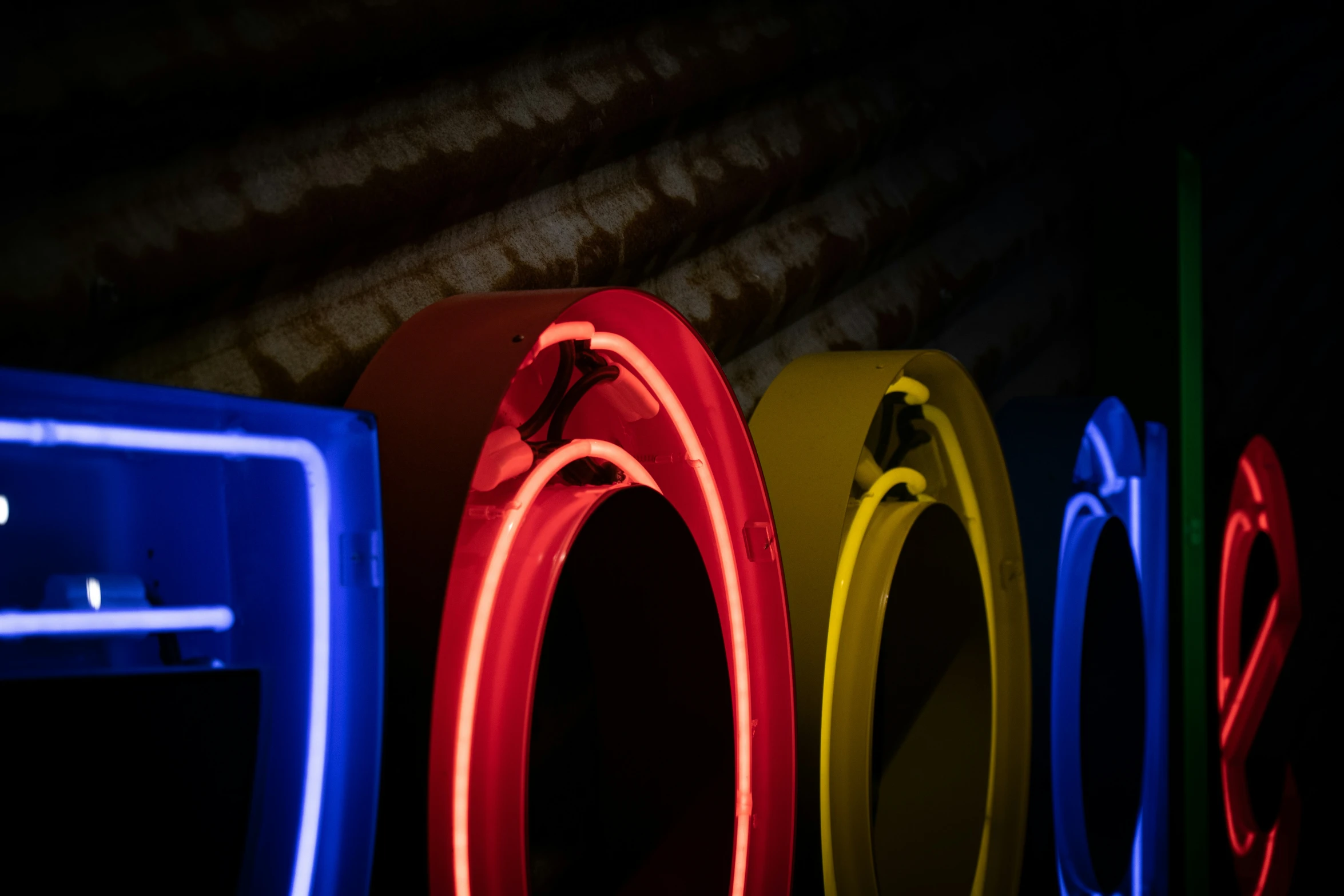 four neon lights glow bright brightly into the dark