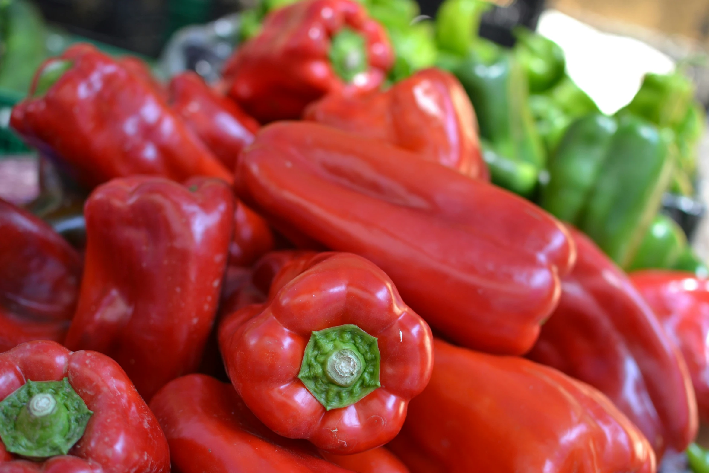 a pile of green peppers and red  pepper