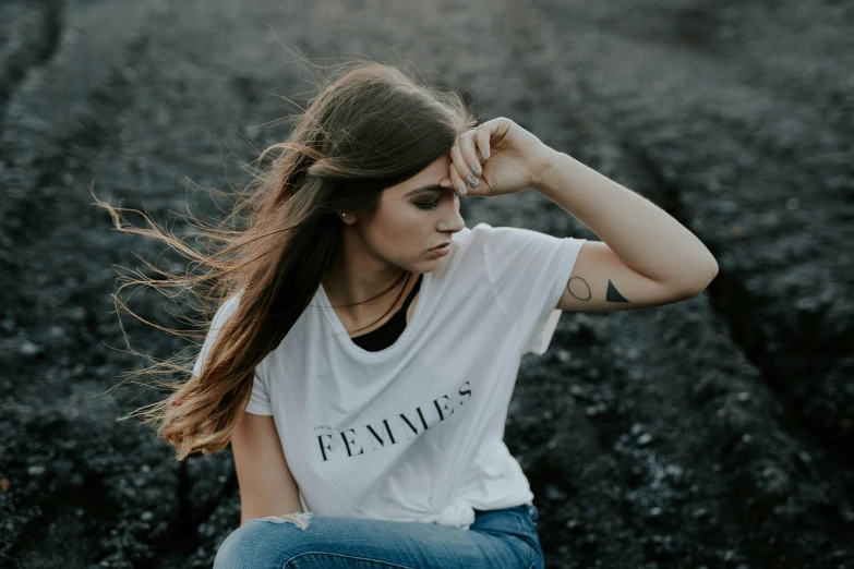 a woman sitting on the ground posing for a picture